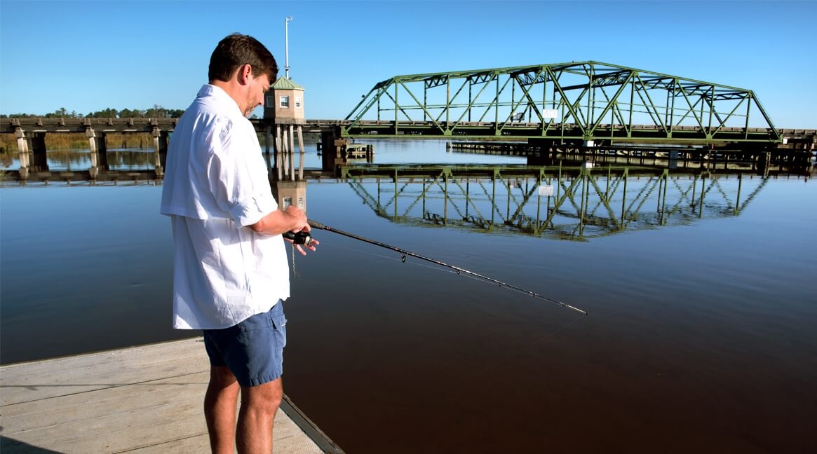 Man fishing on a dock at the Savannah National Wildlife Refuge in Port Wentworth Georgia
