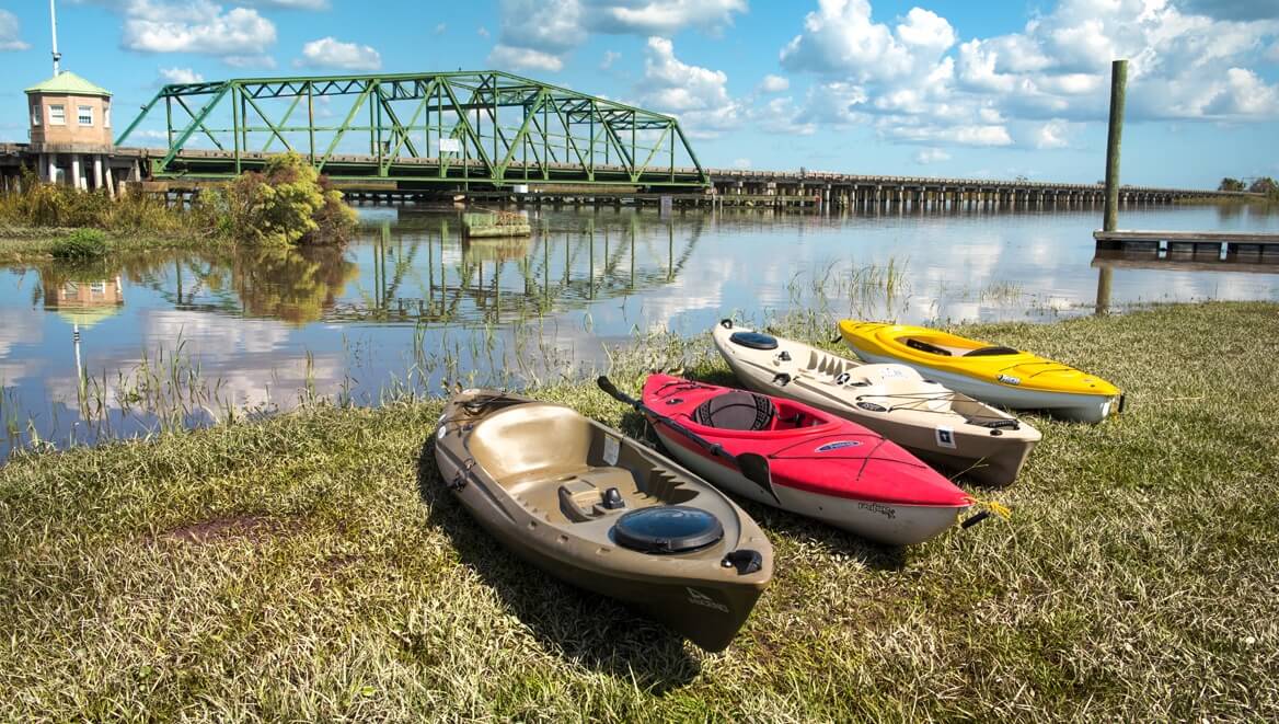 Four kayaks lined up on the shore of the Savannah River in Port Wentworth Georgia